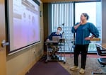 Jacen Greene, left, and Dr. Marisa Zapata look over Point in Time Count data at the regional Incident Command Center in Portland, Jan. 25, 2023. This year marks the first time that the region’s three counties will use a common analysis and methodology.