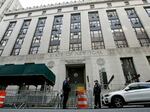 New York police officers stand outside the Manhattan District Attorney's office in New York City on Friday.