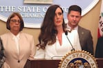 Victoria Burke stands at a podium while discussing proposed protections for victims of assault and abuse during a news conference in California.