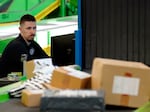 A U.S. Customs and Border Protection technician monitors overseas parcels as they get scanned at a mail inspection facility in Chicago.