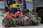 Officials in Jakarta, Indonesia, inspect an engine recovered in November 2018 from a Boeing 737 Max 8 flown by Indonesia's Lion Air that crashed.