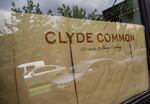 Parked cars reflect on the paper-covered windows of the Clyde Common restaurant in Portland, Ore., on Tuesday, May 12, 2020. Owner Nate Tilden shuttered it when the coronavirus outbreak reached Oregon. He says the restaurant will not come back as it was pre-pandemic and plans to remodel the space to allow for the creation of a market and a smaller tavern-style restaurant.