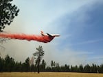 A heavy air tanker flies over the Milli Fire in the Three Sisters Wilderness in Central Oregon.