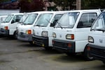 A line of Japanese kei trucks are shown on Tuesday, May 13, 2025, at JDM Car & Motorcycle in Shoreline, Wash.