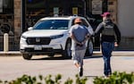 A man is detained by Federal agents as ICE conducts raids on Monday, Feb. 24, 2025. The Trump administration has cracked down on migrants, including many in the U.S. with legal status. Now the White House is exploring a proposal to deport American citizens to be jailed overseas.