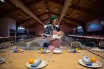 Cloe McMichael, 22, sets the table in the longhouse in Mission, Ore., ahead of the annual Indian New Year ceremony, which is celebrated on the winter solstice. The feast is a celebration of the Confederated Tribes of the Umatilla Indian Reservation’s sacred first foods and their renewal each year. Each place setting includes a set of reusable utensils, provided by the CTUIR Department of Natural Resources. 