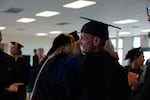 Sam Hannah hugs a faculty member after the ceremony, June 9, 2026. Hannah was awarded the COCC Distinguished Student Service Award and graduated from his class summa cum laude.