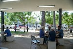 A group of men play dominoes at the Antonio R. Barceló Plaza in Barrio Obrero, the heart of the Dominican community in Puerto Rico. The area has been empty after the first immigration raid in Barrio Obrero in January 2025.