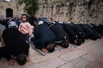 Muslim worshipers pray outside of the Al-Aqsa Mosque in the Old City of Jerusalem on March 15.
