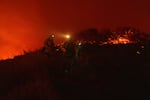 Firefighters work to battle flames as the Franklin Fire burns in Malibu, Calif., Tuesday, Dec. 10, 2024.