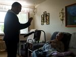 The Rev. Gary Benz offers Holy Communion to Viola Weinhardt, 94, at her home in Glen Ullin, N.D., on May 24. Benz offers Communion and the chance to connect with homebound, often socially isolated seniors who are dealing with health issues.