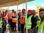 Workers at Idaho Cobalt Operations watch a ceremony opening the mine Oct. 7