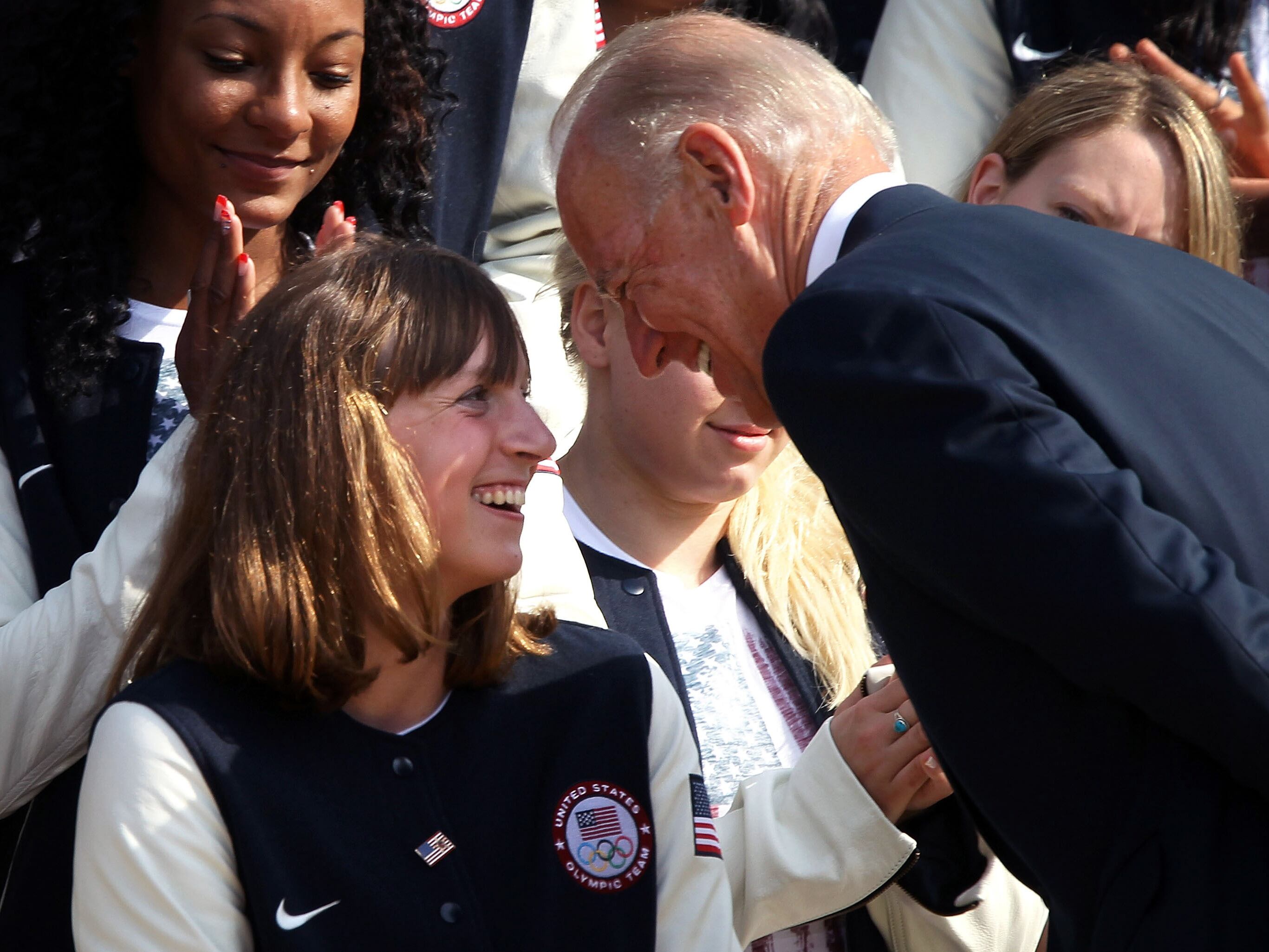 Olympic gold medal swimmer Katie Ledecky speaks with then-Vice President Biden during a White House event honoring Olympians on Sept. 14, 2012.