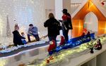 Two families enjoy the winter wonderland set up in downtown Portland for Black Santa PDX on Dec. 7, 2023.