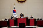 South Korean National Assembly Speaker Woo Won-shik, center, bangs with announcing the president impeachment after the impeachment vote of President Yoon Suk Yeol at the National Assembly in Seoul on Saturday.