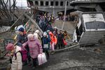 Dozens of people flee a Ukrainian town on foot as the conflict with Russia persists.