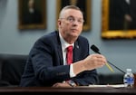 Veterans Affairs Secretary Doug Collins sits at a table in front of a microphone while testifying on Capitol Hill on May 15.