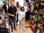 Vice President Harris talks with store owner Nick Meyer while campaigning with Minnesota Gov. Tim Walz and singer Justin Vernon of Bon Iver in Eau Claire, Wis., on Aug. 7, 2024.