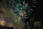 Fireworks explode over the King Taksin Bridge in Bangkok, Thailand.
