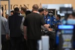 Passengers are screened by TSA agents at O'Hare Airport in Chicago, Thursday, March 26, 2026.