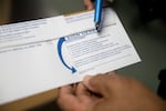 Bill Burgess, Marion County Clerk in Oregon, points out a voter's statement that each voter must sign before returning their ballot, at the Marion County Clerk's Office on Wednesday, Sept. 28, 2022. Washington state ballots also include a similar statement voters must sign.