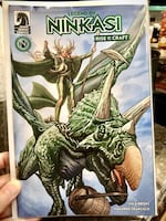 The cover of Ninkasi: The Rise of Craft by Dark Horse Comics. The Goddess of Fermentation appears aloft on her trusty steed, Tricerahops.