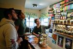 FILE - Budtender Twyla Bessey, right, helps customers buy cannabis at Home Grown Apothecary, Friday, April 19, 2024, in Portland, Ore.