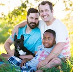 Ben West and Paul Rummell with their son JayQuan and their dog.