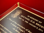 A memorial plaque sits next to a phone booth art piece on Tuesday, Aug. 6, 2024, at the Ferguson Empowerment Center in Ferguson.