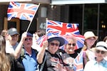Well wishers wave flags before the arrival of Britain's King Charles III and Queen Camilla at a Lansdowne Park community event in Ottawa, Canada, on Sunday.