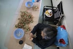 Cassie Katchia works at a table for days to prepare first foods for a feast of gratitude. March 12, 2020