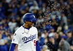 Los Angeles Dodgers' Mookie Betts is showered with sunflower seeds after hitting a two-run home run against the Atlanta Braves during the sixth inning of a baseball game on Tuesday in Los Angeles.