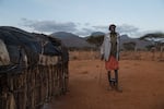 Paris's father, Loituku Lekuuk, stands outside his home. At first he didn't think he could afford to send Paris to school. But he was able to get money from a government official to cover the cost of at least some of the supplies — including $7 for the school uniform.