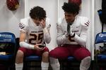 Central Catholic players Silas Starr (8) and Jack Brown (25) listen to music together in the locker room before the start of the game. The Central Catholic Rams played the Lake Oswego Lakers at Hillsboro Stadium in Hillsboro, Oregon, on Dec. 7, 2019. The Rams defeated the Lakers 49-28.