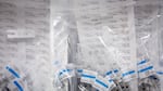 Vaccine doses are prepared in syringes and packaged in zippered plastic bags.