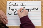 Conrad Thompson writes during after-school Cursive Club, held by teacher Sherisse Kenerson, at Holmes Middle School in Alexandria, Va., on Thursday, Feb. 5, 2026.