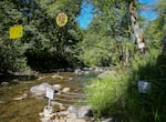 A wire, strung across Three Rivers, marks the line where public land butts up against private land, July 30 2026. 