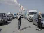 Ukrainians wait in a miles-long jam full of trucks, buses and cars to cross to the border at Medyka, Poland.