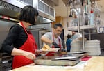 Margie Wood and Jerry Petty prepare meals at Trinity Episcopal Cathedral on Oct. 9, 2024. Every Wednesday, nearly 200 people visit Trinity for a free hot meal.