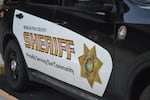 A Deschutes County Sheriff’s Office vehicle parks outside of a candidate forum for interim-sheriff on July 7, 2025.