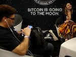 A sign that reads "Bitcoin is going to the moon" is seen during the Bitcoin 2022 Conference at Miami Beach Convention Center in Miami on April 8. The expression has become popular among some Bitcoin enthusiasts.