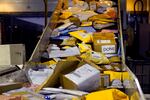 Parcels jam a conveyor belt at a United States Postal Service sorting and processing facility.