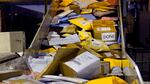 Parcels jam a conveyor belt at a United States Postal Service sorting and processing facility.