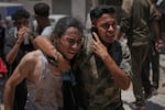 Palestinians react after carrying the bodies of those killed while trying to reach aid trucks entering northern Gaza through the Zikim crossing with Israel, at Shifa Hospital in Gaza City, Sunday.