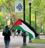 A protester carries a flag in Portland State University’s South Park Blocks, April 26, 2024. 