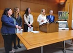 Oregon beach volleyball player Batia Rotshtein speaks to reporters in December 2023 alongside attorney Arthur Bryant, right, rowing club captain Elise Haverland, left, beach volleyball team captain Ashley Schroeder, left, and attorney Lori Bullock, left.