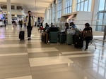 Travelers pass the time at LaGuardia on Monday morning.