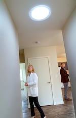 Grand Ronde Tribal Council member Denise Harvey, left, looks at a sun tunnel in a new home construction on Dec. 11, 2023, in Grand Ronde. The Confederated Tribes of Grand Ronde have built 24 climate-resilient single-family homes for elders in partnership with the Energy Trust of Oregon.