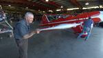 Volunteer Ron Wilkins helps roll a 1937 plane out of the restoration shop to test fire the engine.