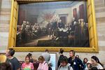 Tourists visit the U.S. Capitol appear under John Trumbull's larger-than-life painting depicting the moment the Declaration of Independence was presented to the Second Continental Congress.